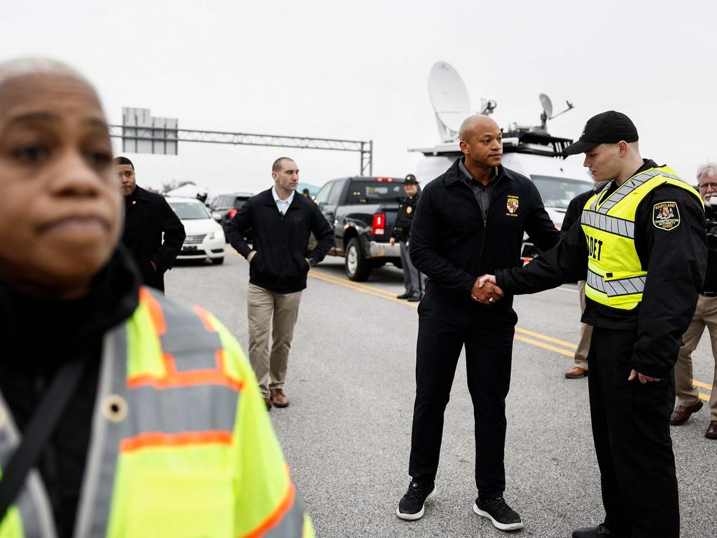 Maryland Governor Wes Moore shakes hands with a Maryland Transportation Authority Cadet near the collapsed Francis Scott Key Bridge. Picture: AFP