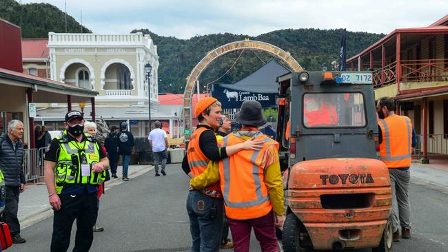 Festival staff console each other in Queenstown's main St as the Unconformity Festival was cancelled. Picture: Chris Crerar