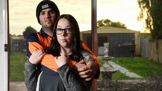 Ashley Harraghy, pictured with partner Phill Juggins, suffered terrible injuries after two dogs attacked her in the pair’s Cranbourne North backyard. Picture: Penny Stephens