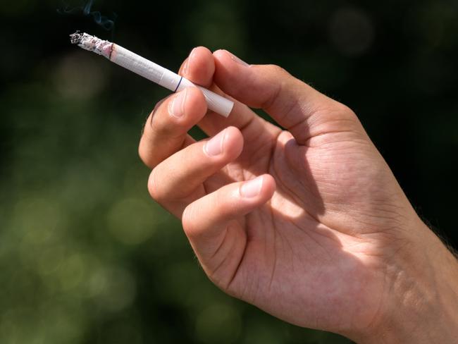 Young man smoking cigarette, inhaling toxic tabacco smoke, smoking kills, warning  Picture: istock