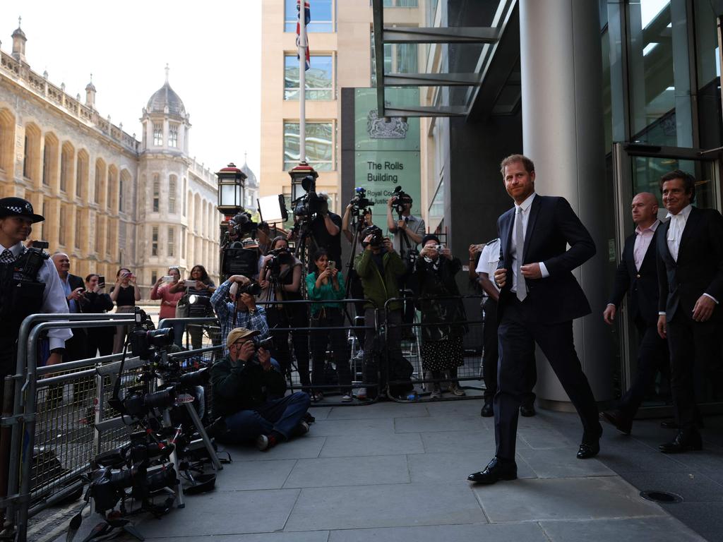 Prince Harry walks ahead of his barrister David Sherborne as he leaves the Royal Courts of Justice. Picture: AFP