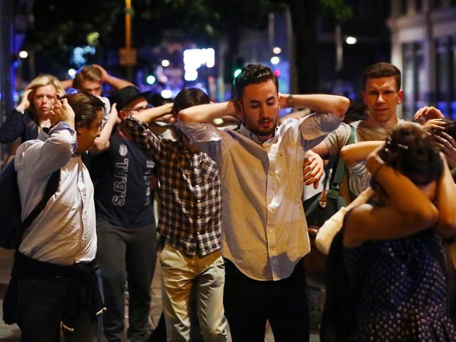 People leave the area with their hands up after an incident near London Bridge in London. Picture: Reuters