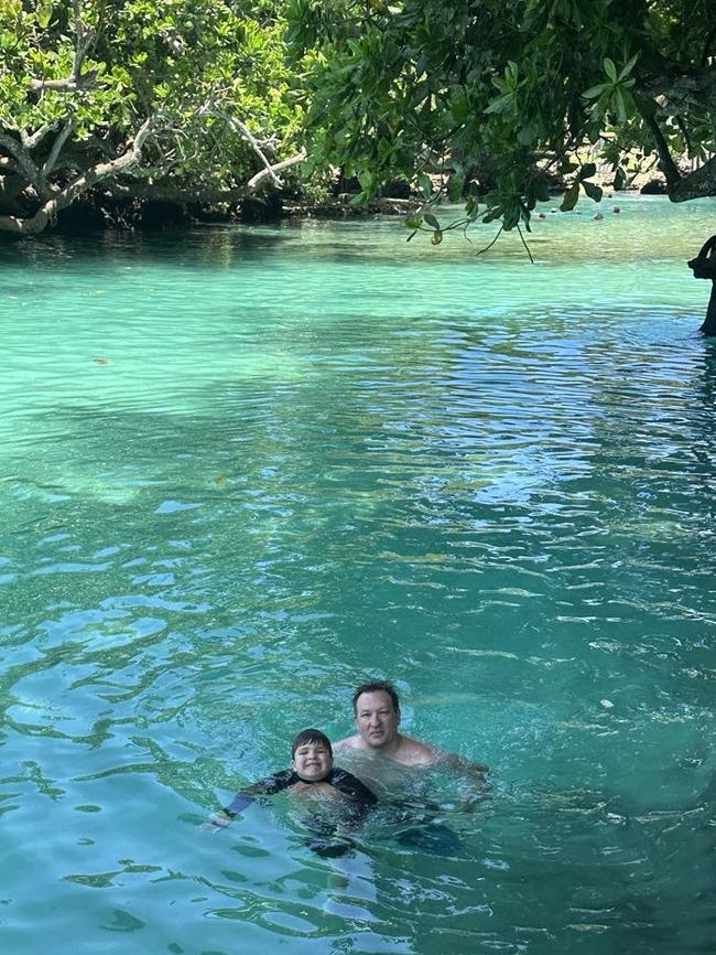 Mischa King and his son Ethan, 5, swim in the Blue Lagoon before the earthquake. Picture: Supplied