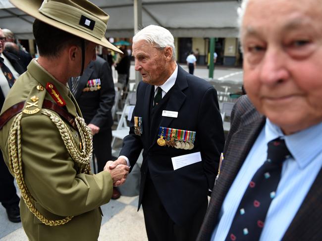 Major General Stewart Smith (left) shakes hands with WWII veteran Bill Corey during a Victory in the Pacific Day 70-year anniversary commemoration ceremony in Brisbane. Picture: AAP