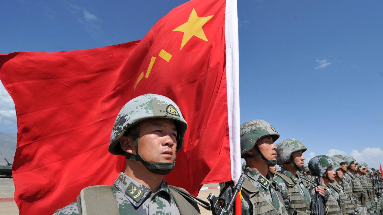 A Chinese soldier holds a Chinese flag during Peace Mission-2016 joint military exercises of the Shanghai Cooperation Organization (SCO). Picture: Vyacheslav Oseledko/AFP