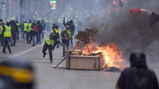 Protesters clash with riot police near the Champs Elysees in Paris on Saturday. Pic: AFP