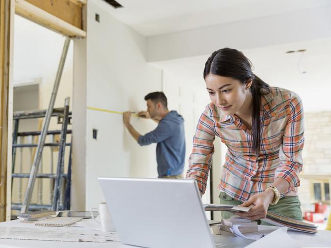 Young couple working on home renovations