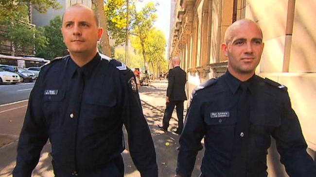Senior Constable Tom Wospil and First Constable Ben Ashmole outside the Supreme Court of Victoria.