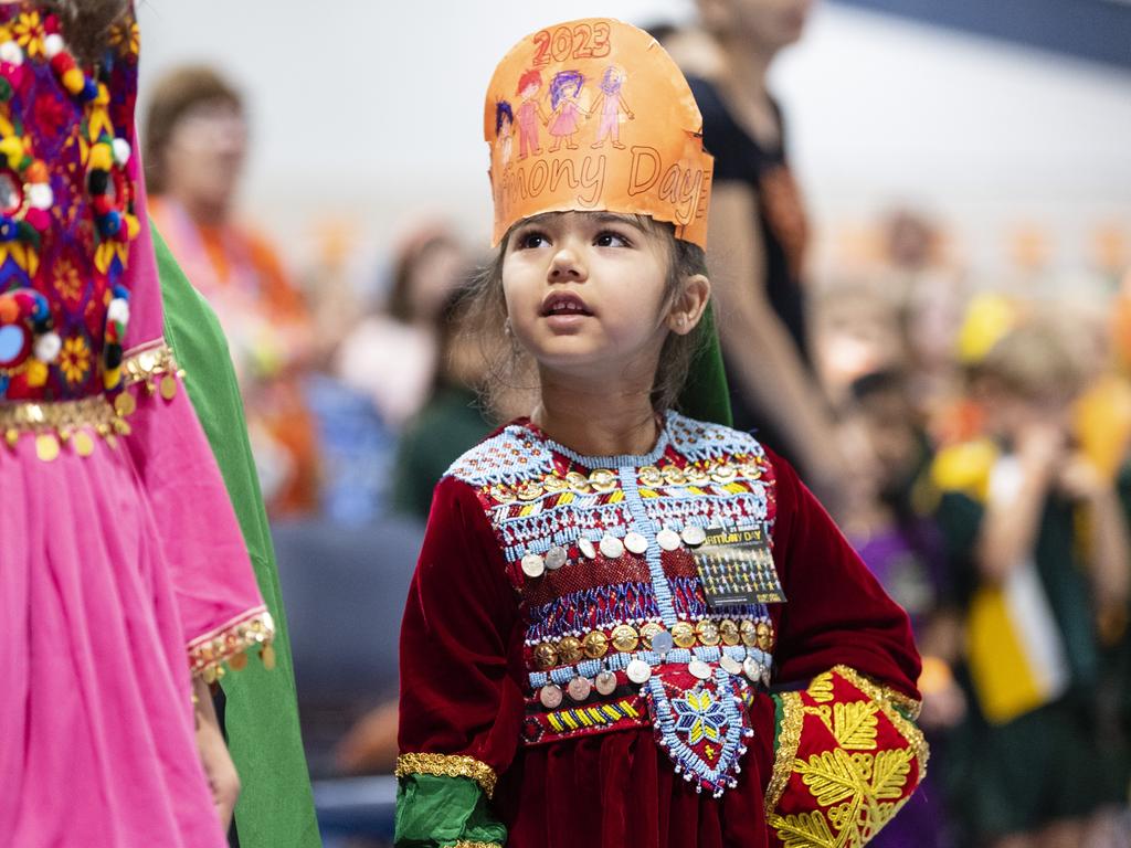 Emma Ahmadi stands with fellow students of the Afghanistan community during Harmony Day celebrations at Darling Heights State School. Picture: Kevin Farmer