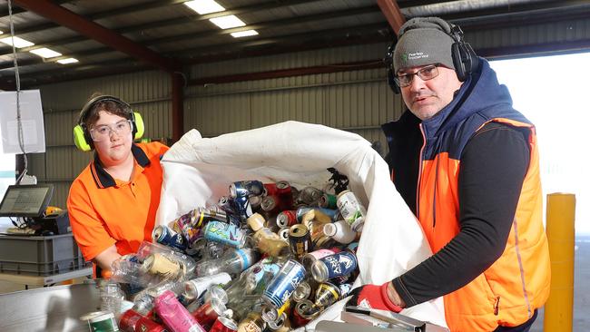 Brotherhood of St Laurence Breakwater depot workers Emily Ford and Andrew Merrette unload a delivery of containers for recycling. Picture: Alan Barber