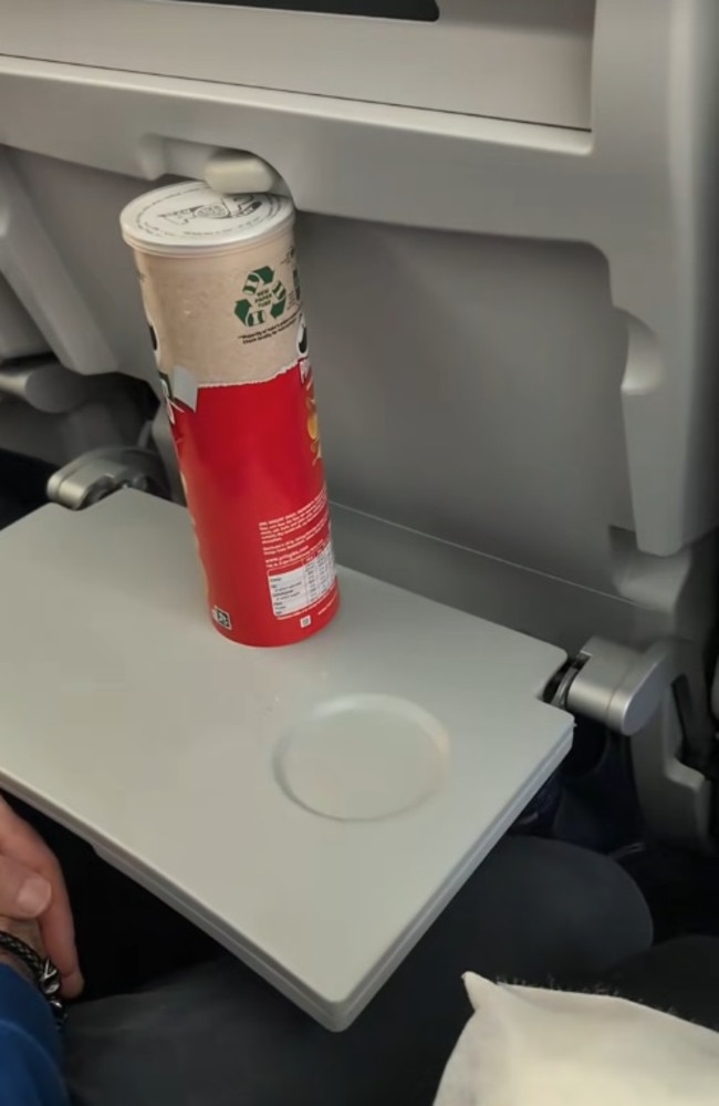 A passenger used a Pringles tube to stop the person in front from reclining their seat. Picture: TikTok/ClareDuggan