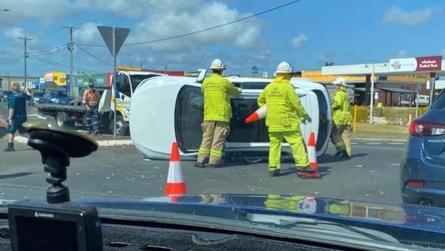 A car flipped on its side after a crash in Hervey Bay.