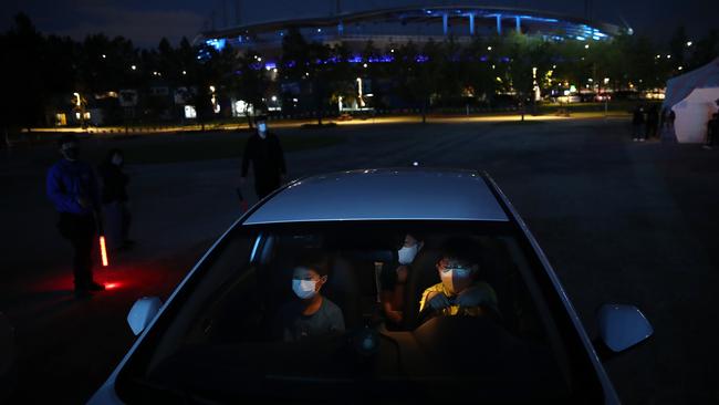 A family arrive at a drive-thru circus in Seoul on Friday. Picture: Getty Images