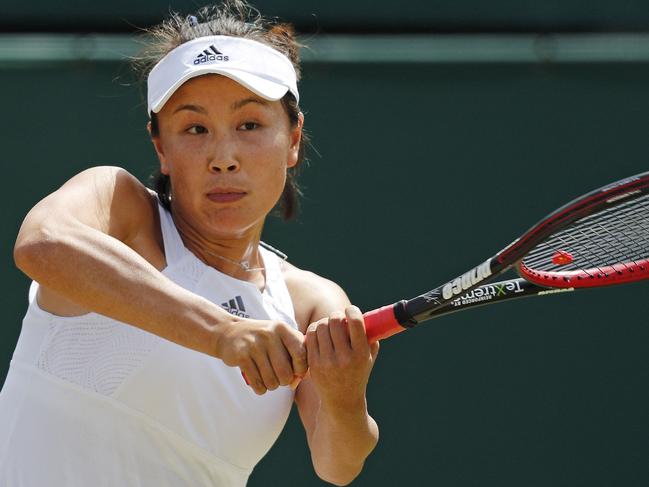 (FILES) This file photo taken on July 7, 2017 shows China's Peng Shuai hitting a return against Romania's Simona Halep during their women's singles third round match on the fifth day of the 2017 Wimbledon Championships at the All England Lawn Tennis Club in Wimbledon. - From human rights to coronavirus and now tennis star Peng Shuai, preparations for February's Beijing Olympics have been overshadowed by several controversies. (Photo by Adrian DENNIS / AFP) / TO GO WITH AFP STORY by Helen ROXBURGH RESTRICTED TO EDITORIAL USE