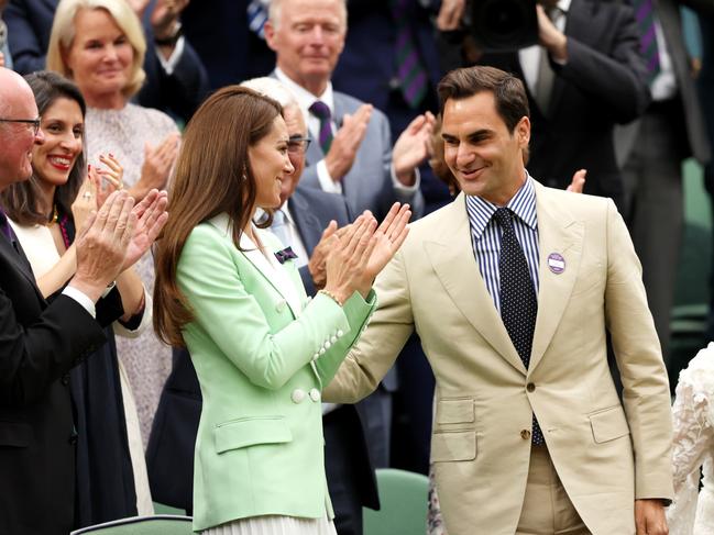 Roger Federer touches the Princess of Wales on the back in an apparent breach of royal protocol. (Photo by Clive Brunskill/Getty Images)