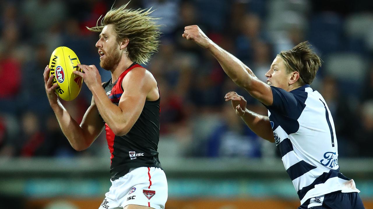 Geelong’s Rhys Stanley, right, chases Bomber Dyson Heppell.