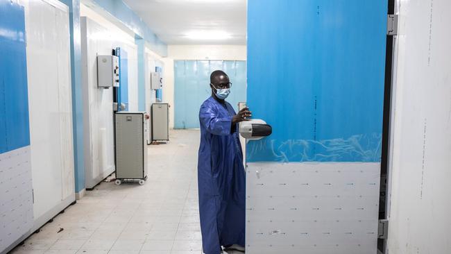 Ousseynou Badiane, head of Senegal’s vaccination program, opens the door of a newly built cold room for vaccine storage at Fann Hospital in Dakar. Picture: AFP