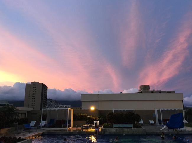 Not much can top a sunset by the pool on a Waikiki rooftop. Picture: Michael Wayne.