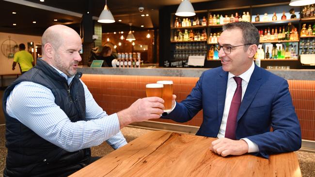 Premier Steven Marshall and former Adelaide Crows player Mark Ricciuto are seen enjoying a beer during a media opportunity at the Alma Hotel in June last year. Picture: David Mariuz