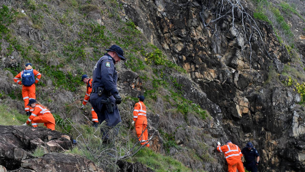 SES and police are pictured during the initial search for Theo Hayez in thick bushland between The Pass and Wategoes.