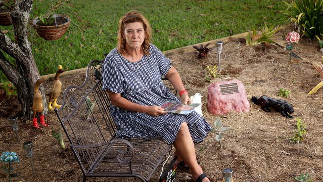 Anita Warburton, wife of fatal crash victim Michael Warburton, sits in a memorial garden with Michael’s ashes interned in a rock. Photo: Steve Pohlner