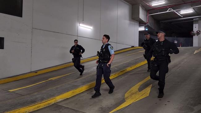 Police rush into the basement car park where the former Lone Wolf bikie was shot. Picture: TNV