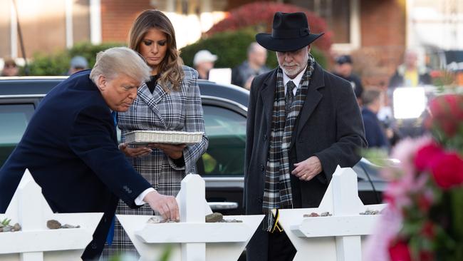 Donald and Melania Trump, alongside Rabbi Jeffrey Myers, pay their respects at the Tree of Life Synagogue in Pittsburgh on October 30, 2018. Picture: AFP