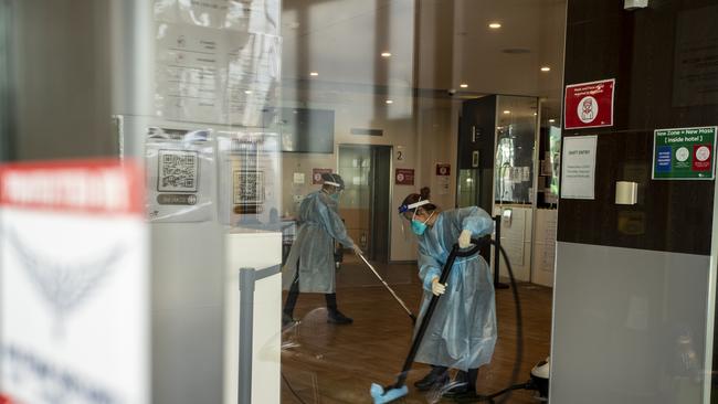 Cleaners wearing full PPE while working at the disinfection of the Holiday Inn hotel on February 10 Photo by Diego Fedele/Getty Images