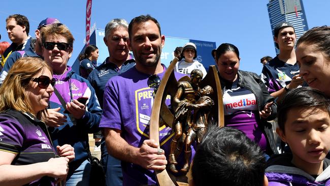 Storm captain Cameron Smith celebrates the 2017 grand final win with fans.