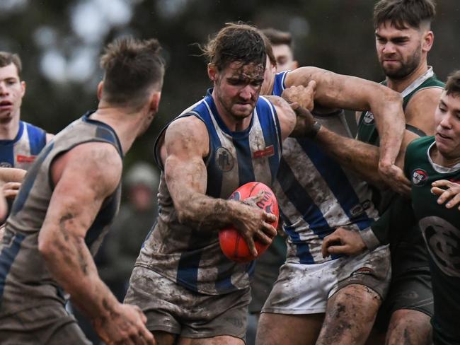 Macleod and Greensborough slog it out in the wet in the Northern Football League. Pictures: Nathan McNeill.