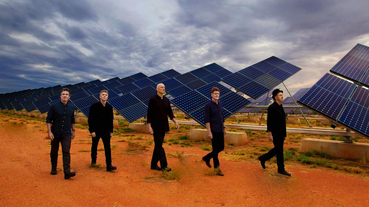 Midnight Oil band members Rob Hirst, Martin Rotsey, Peter Garrett, Bones Hillman and Jim Moginie with the Uterne Solar Power Station in 2017. Picture: Oliver Eclipse