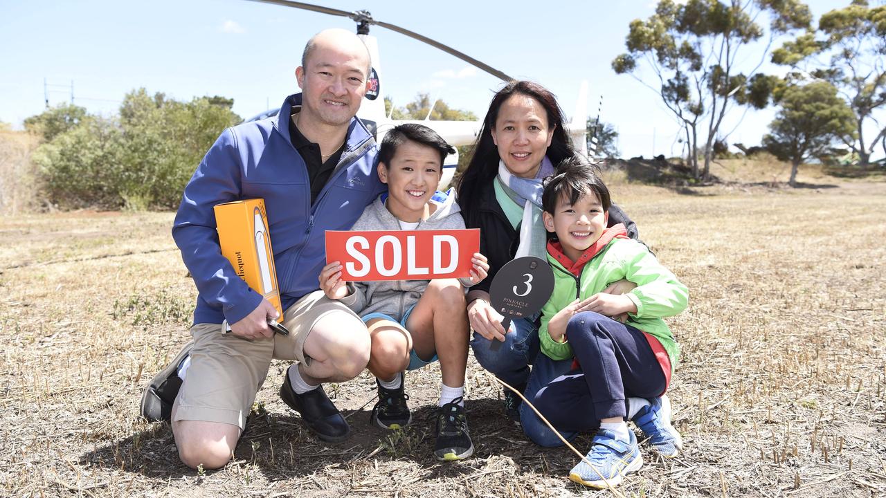 Boon, Matthew, Janet and Ryan Kweh were feeling sky high after securing a 1260sq block at Pinnacle Newtown. Picture: Alan Barber