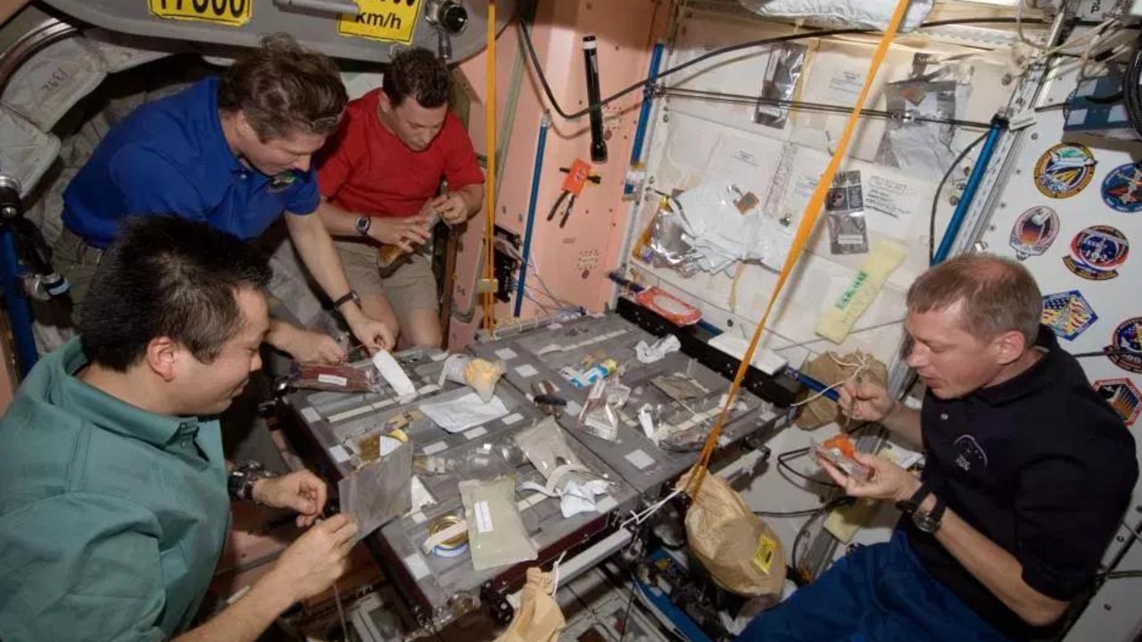 Astronauts rehydrate their food using a special machine, then tuck in, making sure no bits float away. Picture: ESA