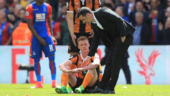 Curtis Davies of Hull City and Marco Silva manager of Hull City console Sam Clucas.