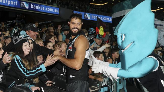 Paddy Ryder with fans and the Port mascot Thunder after the Power’s win in Showdown 44. Picture: Sarah Reed