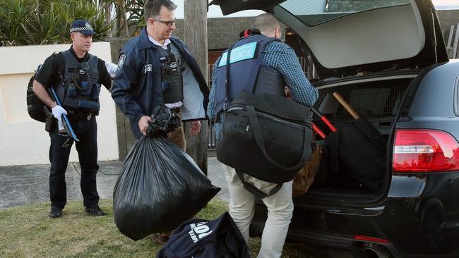 Police take items from the nightclub tsar’s home during the recent raids. Picture: Richard Dobson