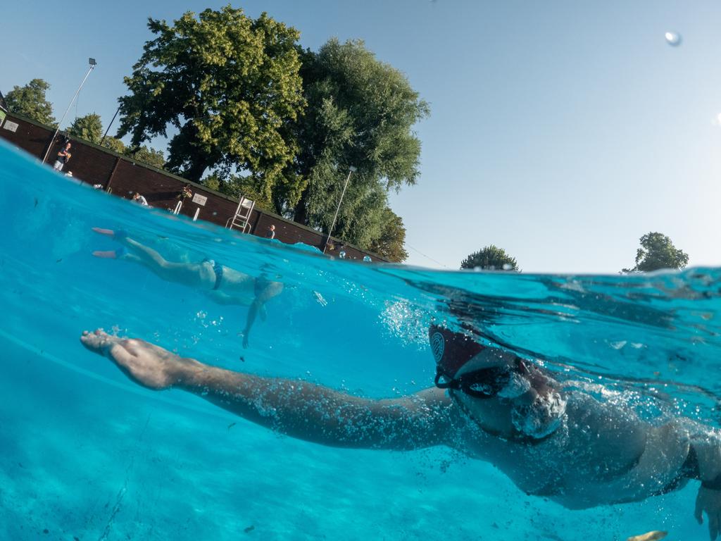 Swimmers enjoy an early morning swim in the cool water of Jesus Green lido in Cambridge, England. Picture: Getty Images