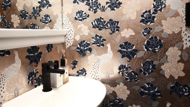 The bathroom features exquisite wallpaper. Picture: John Appleyard