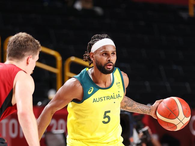 Patty Mills wears a Superman suit under his Boomers singlet.