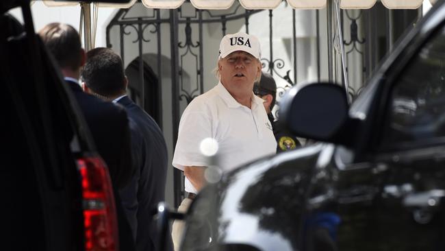 President Donald Trump gets out of his car and heads into the White House in Washington after spending the day golfing.