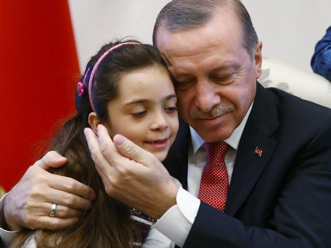 Turkey's President Recep Tayyip Erdogan embraces Bana Al-Abed, seven, from Aleppo in Syria. Picture: Presidency Press Service /Pool Photo via AP