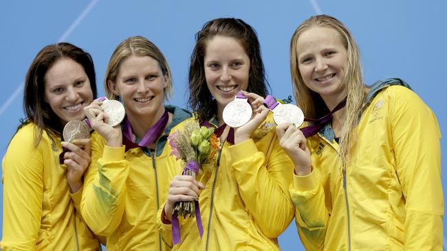 Melanie Schlanger (right) celebrates the Australia's women's 4x100m medley relay team's gold medal at the 2012 London Olympics with teammates Emily Seebohm, Leisel Jones and Alicia Coutt.