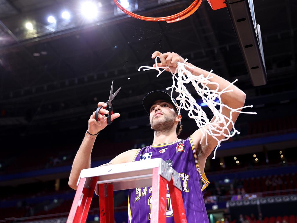Cooks cuts down the net following the Kings’ win over the JackJumpers in the grand final decider. Picture: Getty Images