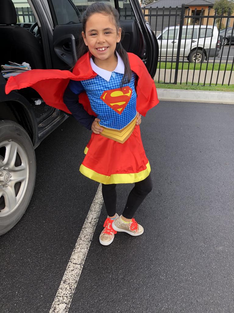 Emilia dressed as Super Girl.