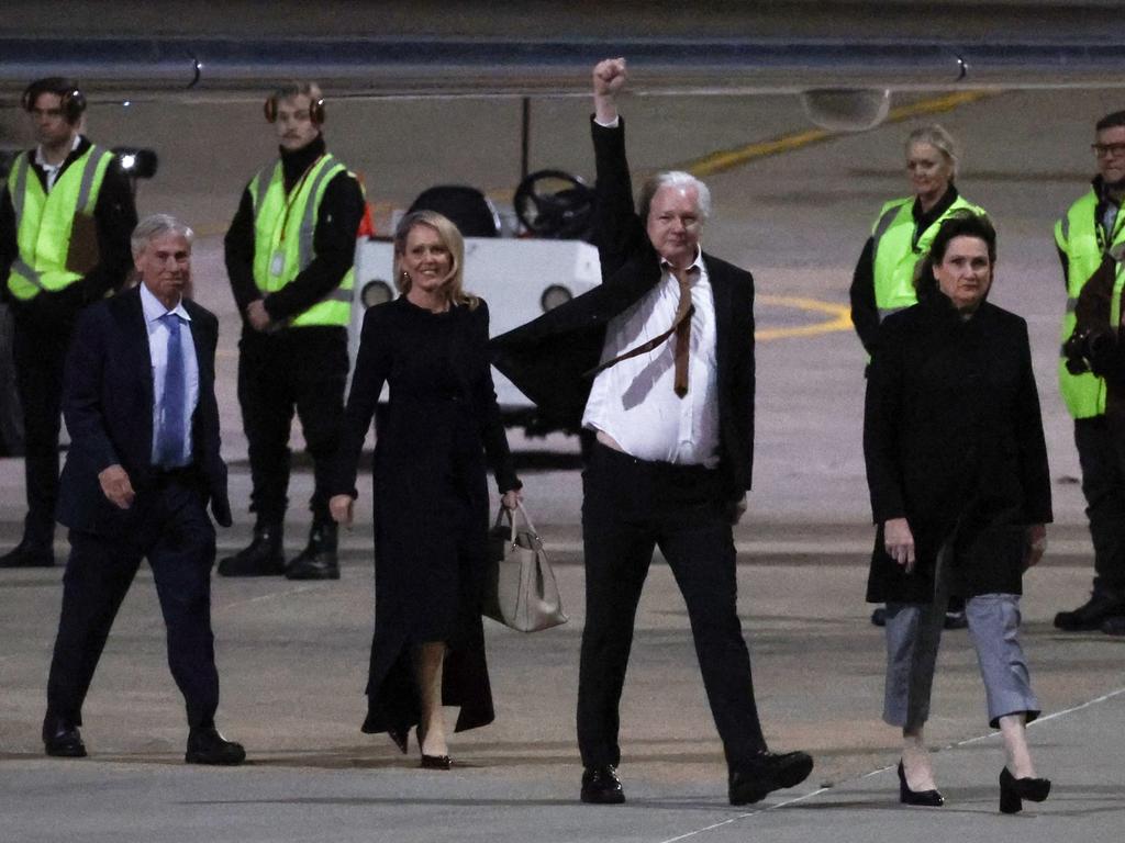 Free as a bird: WikiLeaks founder Julian Assange (C) raises his fist upon arrival at Canberra Airport in Canberra on June 26, 2024, after he pleaded guilty at a US court in Saipan to a single count of conspiracy to obtain and disseminate US national defence information.. WikiLeaks founder Julian Assange returned home to Australia to start life as a free man June 26 after admitting he revealed US defence secrets in a deal that unlocked the door to his London prison cell. Picture: AFP