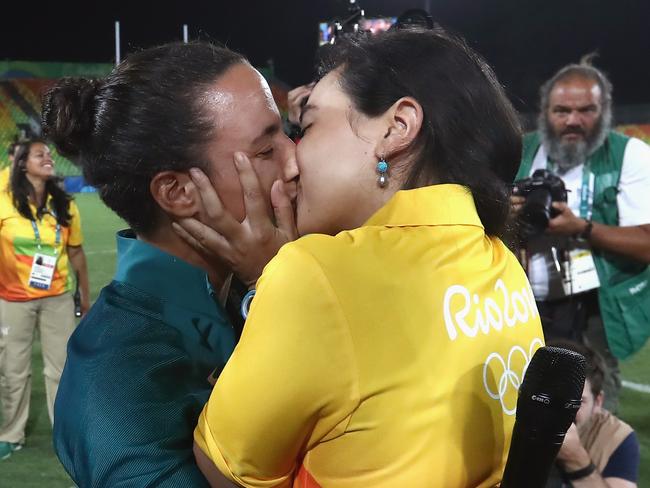 RIO DE JANEIRO, BRAZIL - AUGUST 08: Volunteer Marjorie Enya (R) and rugby player Isadora Cerullo of Brazil kiss after proposing marriage after the Women's Gold Medal Rugby Sevens match between Australia and New Zealand on Day 3 of the Rio 2016 Olympic Games at the Deodoro Stadium on August 8, 2016 in Rio de Janeiro, Brazil. (Photo by Alexander Hassenstein/Getty Images)