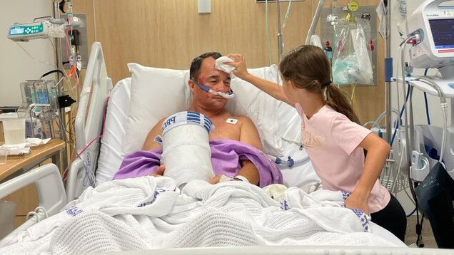 Jason Taylor being tended to in hospital by his daughter Jess. Picture: Twitter.