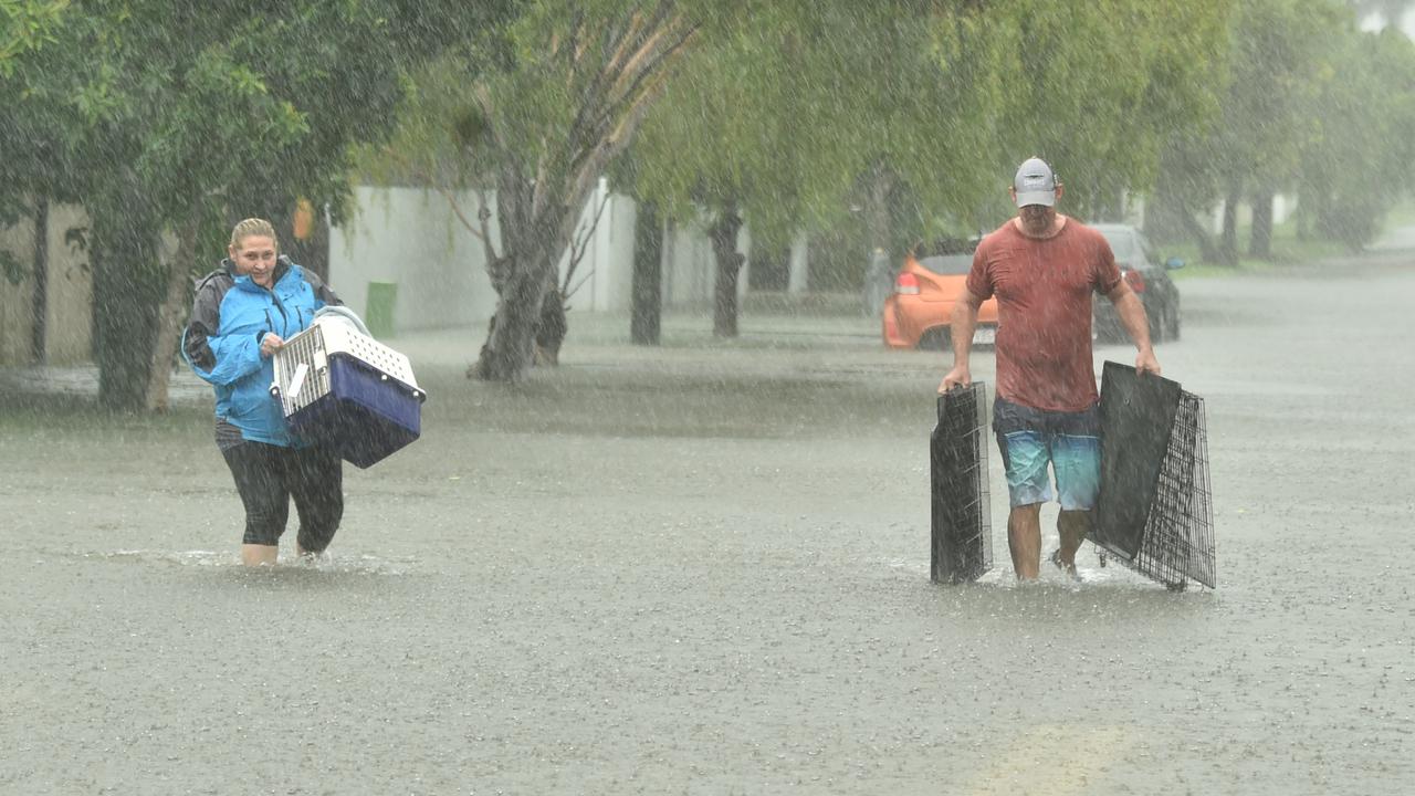 Jo Martin carries her cat Kramer and Peter Sharpe in Carmody Street, Rosslea. Picture: Evan Morgan