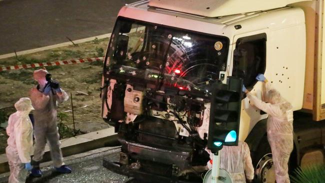 Authorities investigate a truck after it plowed through Bastille Day revelers in the French resort city of Nice. (Sasha Goldsmith via AP)