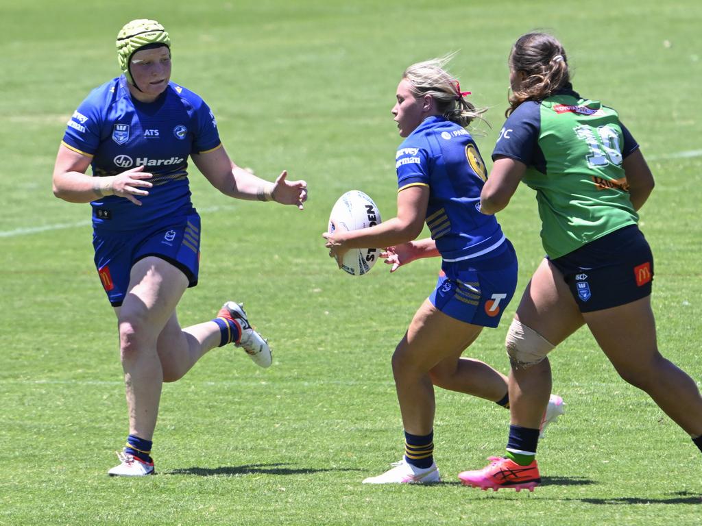 Rory Muller looks to get a pass to Tess McWilliams. Picture: Martin Ollman